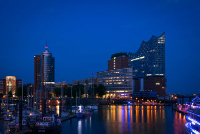 Illuminated port of hamburg against clear sky