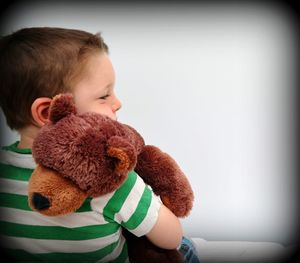 Portrait of cute boy with toy