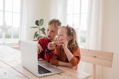 Kids showing chocolate to family on a video call during isolation