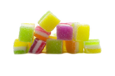 Close-up of multi colored candies against white background