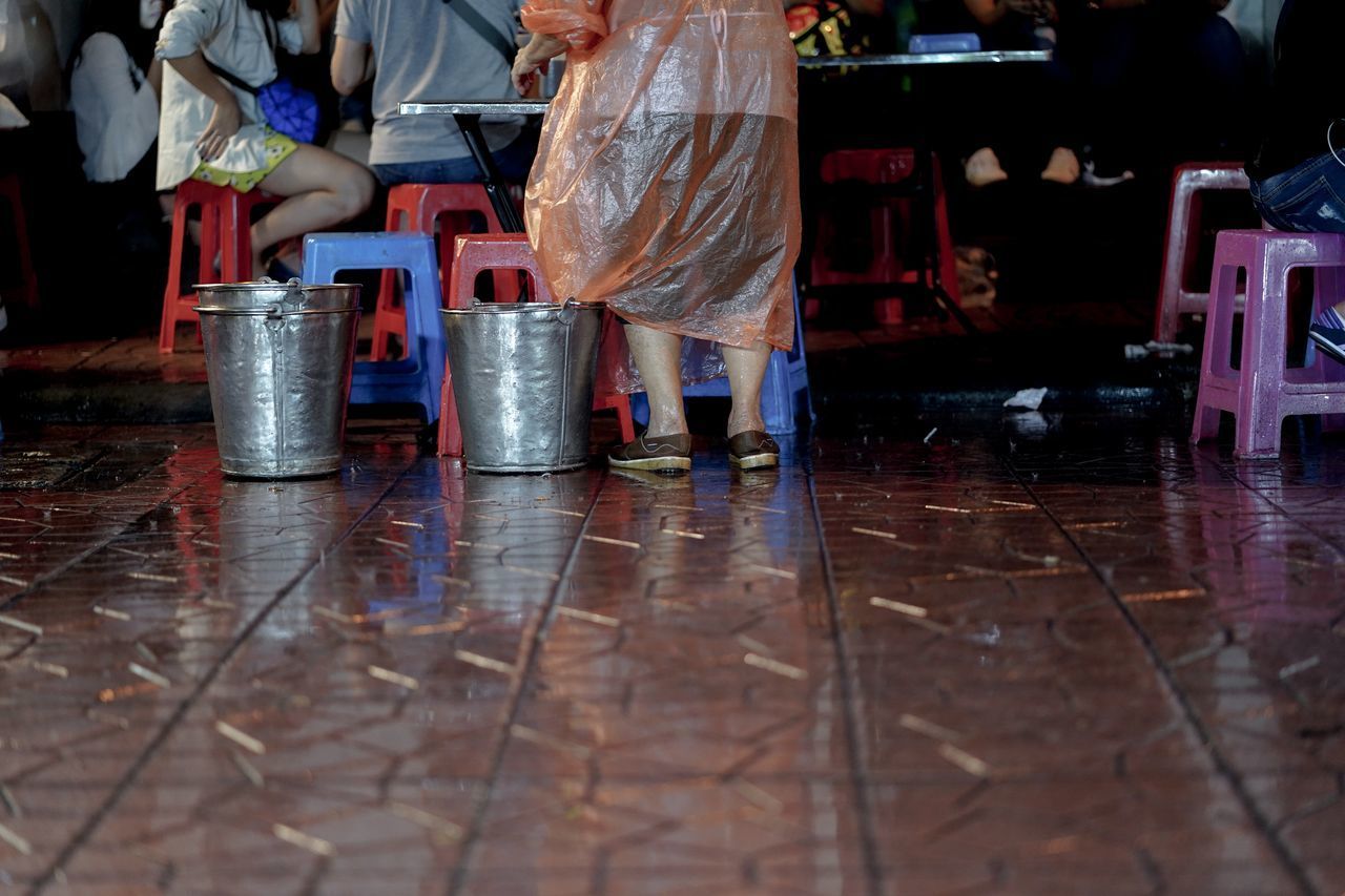 LOW SECTION OF PEOPLE ON WET TABLE