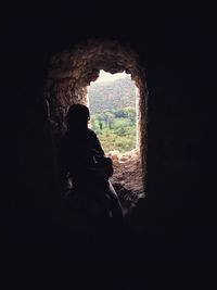 Silhouette people in cave