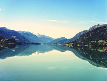 Scenic view of lake and mountains against sky