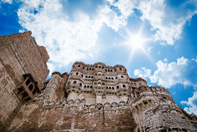 Low angle view of fort against cloudy sky