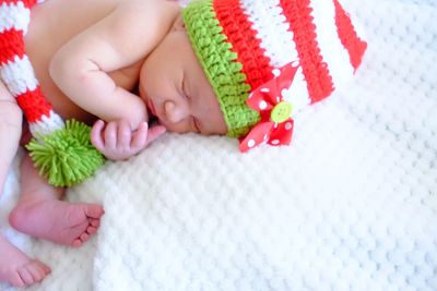 Close-up of baby hand on bed