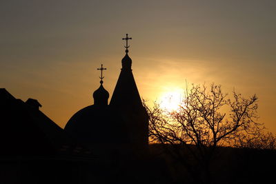 Low angle view of silhouette building against sky during sunset