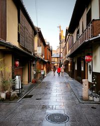 Woman walking on street in city