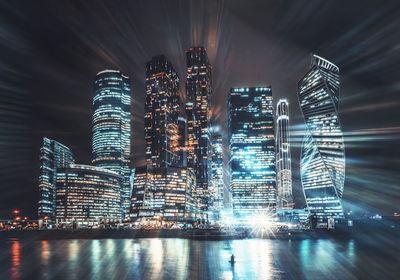 Illuminated city against sky at night