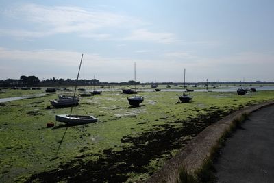 Boats on field against sky