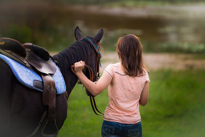 Rear view of woman with horse