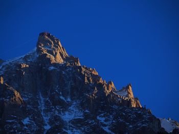 View of mountain range against blue sky