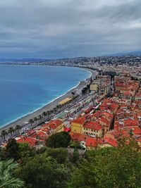 High angle view of townscape by sea against sky