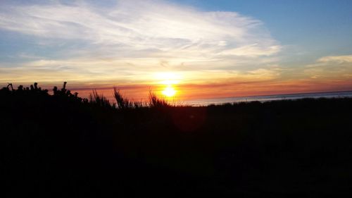 Scenic view of silhouette landscape against sky during sunset