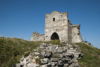 Low angle view of ruins against clear blue sky