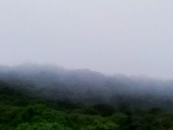 Scenic view of mountains in foggy weather