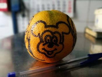 Close-up of smiley face on table