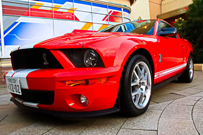 Red vintage car on street in city