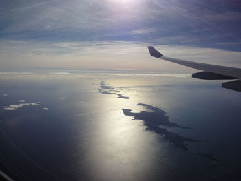 Cropped image of airplane flying over sea