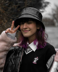 Portrait of young woman wearing hat