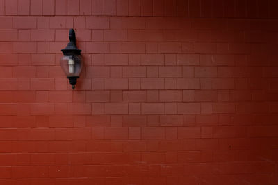 Close-up of illuminated red brick wall