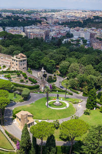 High angle view of trees and buildings in city