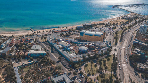 High angle view of cityscape by sea against sky