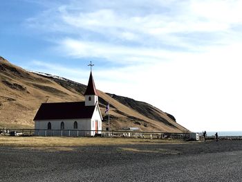 Icelandic church in vik against cloudy sky 