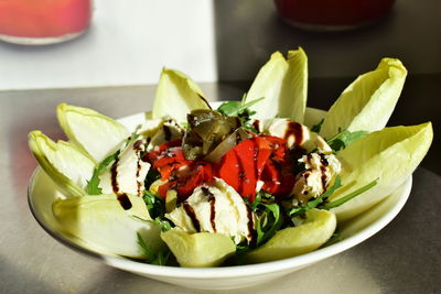 Close-up of chopped fruits in bowl on table