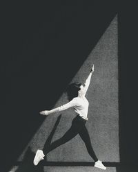 Woman dancing against wall