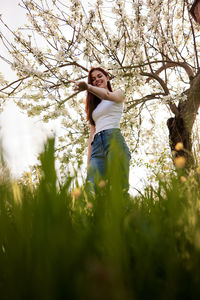 Portrait of young woman standing on field