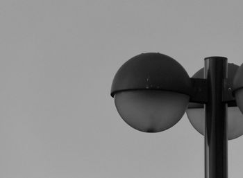 Close-up of lamp post against clear sky