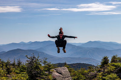 Full length of man paragliding against mountain range