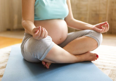 Low section of woman sitting on floor