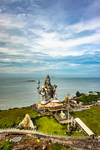 Shiva statue isolated at murdeshwar temple aerial shots with arabian sea in the backdrop