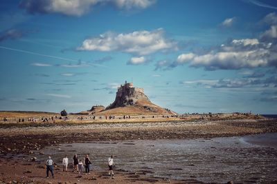 Scenic view of lindisfarne castle  and its hill