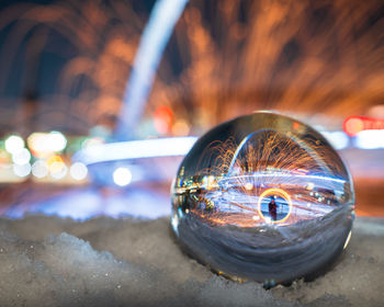 Mid adult man with wire wool reflecting on crystal ball