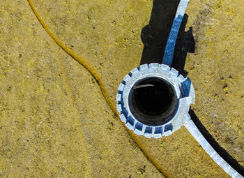 High angle view of yellow pipe on wall