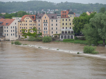 Buildings by river in town