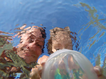 Father and daughter seen from underwater