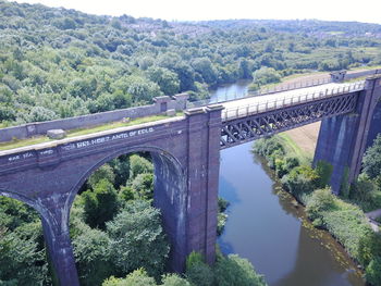 Bridge over river amidst trees