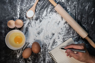High angle view of person preparing cookies on table