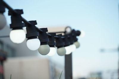 Low angle view of lighting equipment against sky