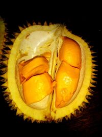 Close-up of orange fruit against black background