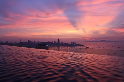 Scenic view of sea against romantic sky during sunset