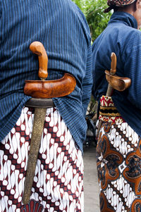 Low section of men standing on wood