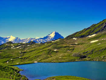 Scenic view of mountains against clear blue sky