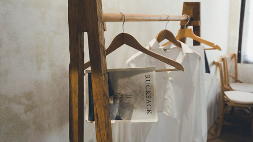 Close-up of clothes hanging on wooden wall at home