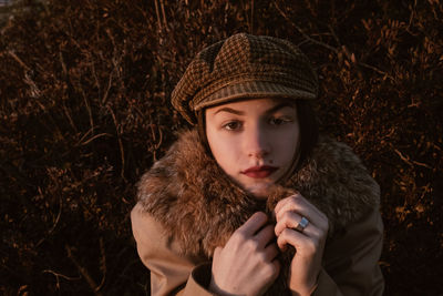 Portrait of young woman on field