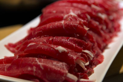 Close-up of meat in tray on table