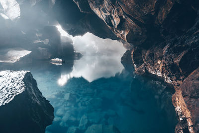 Scenic view of rock formation by sea against sky